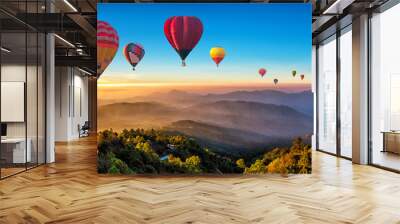 Colorful hot air balloons flying over mountain at Dot Inthanon in Chiang Mai, Thailand.. Wall mural