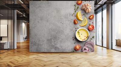 Food cooking background on grey stone rustic table with fresh ingredients, vegetables, herbs, spices, olive oil from above with space for text Wall mural