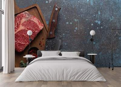 Raw meat beef marbled prime cut steak Ribeye on wooden cutting board and rustic concrete kitchen table background from above with big knife and spices, beefsteak concept Wall mural