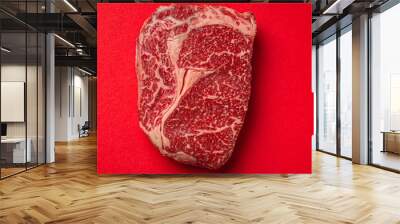 Raw meat beef prime cut steak Ribeye on clean red background from above, beefsteak concept banner minimalism with space for text Wall mural