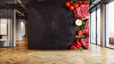 raw meat steaks on a dark background ready to roasting Wall mural