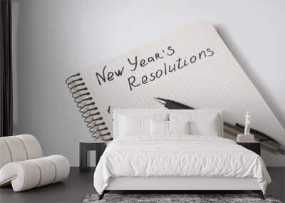 Phrase New Year's resolutions in the notebook and blank page, pen. Wall mural