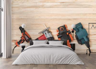 Set of hand carpentry power tools for woodworking lies on a light wooden background. Directly above Wall mural