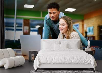 Students, man and woman with laptop, education and library with notes for learning, development and research. Person, happy and partner with reading, scholarship and studying in hall at university Wall mural