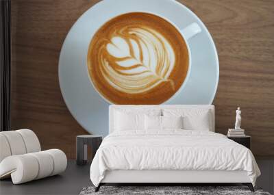  Hot latte coffee with latte art in the white cup on the white background. Copy space. Wall mural