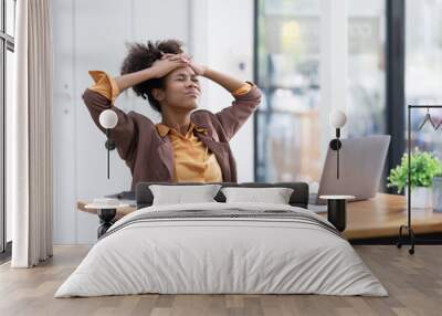 Young African American businesswoman working with pile of documents at office workplace,  feeling sick at work, stress from work, overworked, problem, unhappy.	 Wall mural