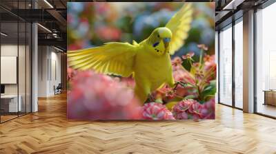 A bright yellow budgerigar spreads its wings while exploring a lush garden filled with blooming flowers on a sunny day Wall mural