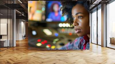 A woman focuses intently on her work in a television control room, managing operations during a live broadcast with multiple screens Wall mural