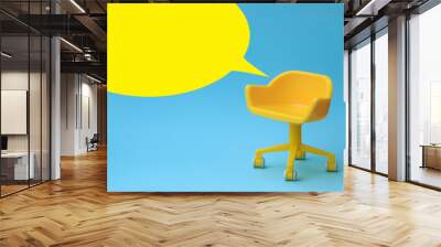 concept of vacant chair. yellow stool on blue clean background. photo in minimal style. Wall mural