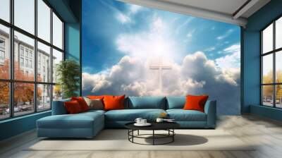 Religious background with cross of God with light rays coming from the clouds in blue sky Wall mural