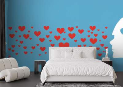 Silhouette of two heads facing each other, exchanging red hearts symbolizing love and caring emotions Wall mural