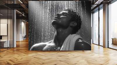 Water cascades down as a man stands in a shower, embracing a moment of tranquility and refreshment in soft lighting Wall mural