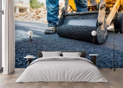 A worker inspecting the quality of freshly laid asphalt on a road construction site Wall mural