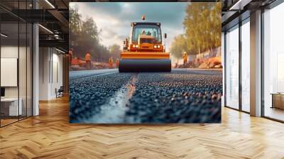 highway construction, road roller working on asphalt at highway under construction with machinery and workers in background. Wall mural