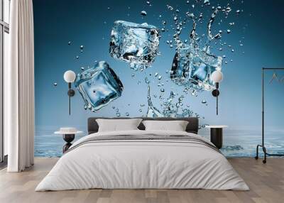 Three ice cubes splash into water, creating ripples and droplets against a serene blue background. Wall mural