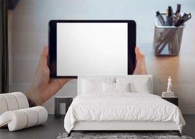 Closeup of woman hand holding digital tablet on the table and the screen is blank. Wall mural