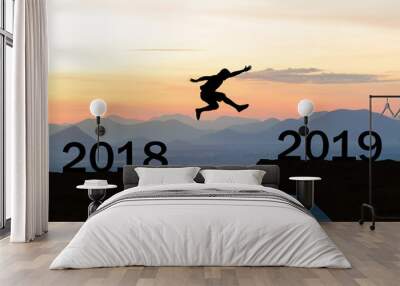 Happy New Year 2019 Men jump over silhouette mountains and sun Wall mural