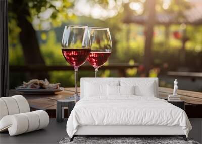 A wine glass with red wine on a picnic table Wall mural