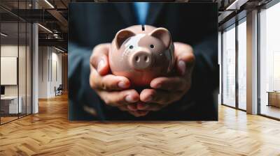 Businessman holding piggy bank for saving money the money saving concept for investment Wall mural