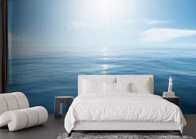 Closeup surface of calm ocean blue sea water with sunshine and clouds behind. Abstract Background Texture. Wall mural