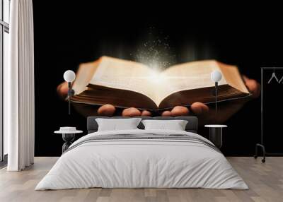 Man holds holy bible book on black background. Wall mural