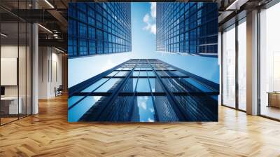 blue glass window office building from an upward angle, with blue sky and white clouds Wall mural