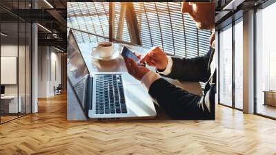 business man using internet on  smart phone and laptop Wall mural