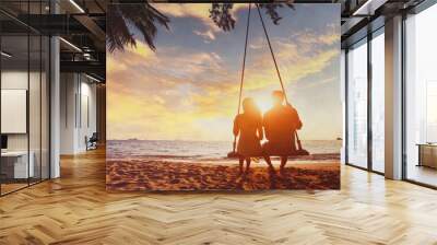 couple at sunset tropical beach, silhouettes of young man and woman on honeymoon Wall mural