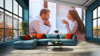 dating, man and woman laughing together in restaurant, happy couple drinking coffee and eating break Wall mural