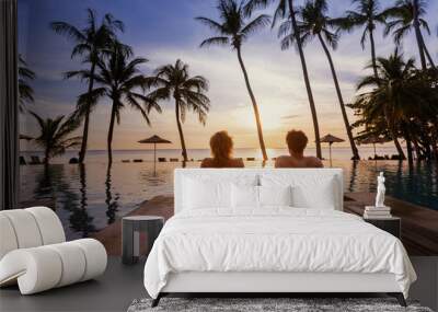 holidays, couple relaxing near swimming pool in luxury hotel resort at sunset on tropical island, honeymoon vacation travel Wall mural