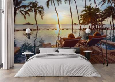 honeymoon couple relaxing near beach swimming pool in luxurious hotel, banner background, vacation travel Wall mural