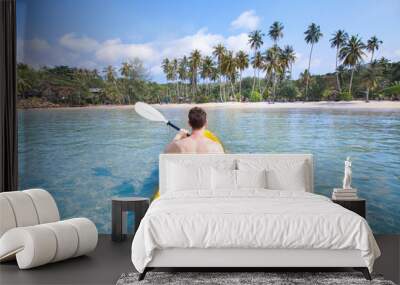 kayaking on tropical beach, travel to Asia, summer holidays, tourist paddling on kayak in turquoise sea water Wall mural