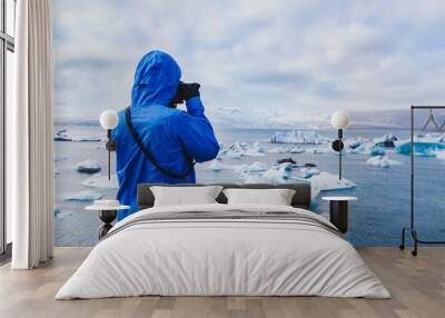 nature travel photographer, person taking photo of arctic icebergs in Iceland Wall mural