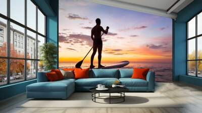 paddleboard on the beach at sunset, paddle standing in Thailand Wall mural