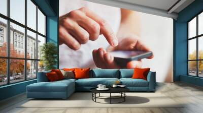 person using mobile application on smartphone, abstract close up of hands Wall mural