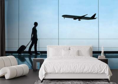 silhouette of woman in airport traveling with luggage suitcase, travel and tourism concept, airplane tickets Wall mural