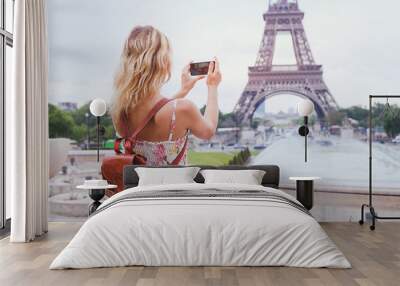 tourist taking photo of eiffel tower in paris with compact camera or smartphone, travel in europe Wall mural