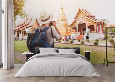 travel to Asia, tourist photographer taking photo of temple or landmark, tourism in Thailand Wall mural