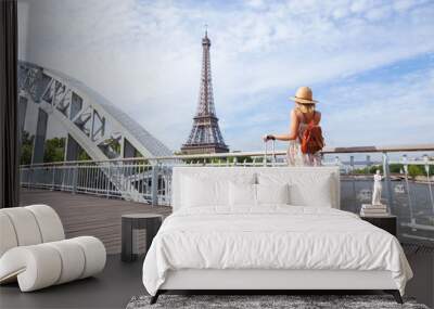 travel to Paris, Europe tour, woman with suitcase near Eiffel Tower, France. Wall mural