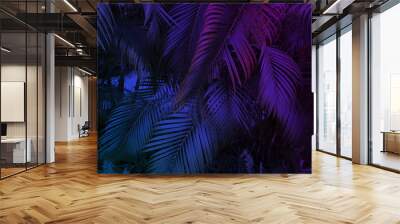 tropical leaf summer background with blue and purple party glow colors, exotic jungle palm tree leaves toned Wall mural