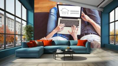 young family couple choosing new home online, search real estate to buy or rent, house for sale on screen of computer Wall mural