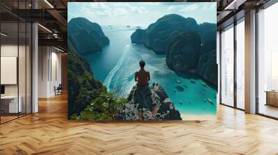 A lone traveler enjoys a panoramic view of may beach, Krabi, Thailand and turquoise waters from a scenic overlook. The movie lights. Wall mural