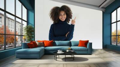 Joyful young professional having a new idea, pointing index finger up. African American businesswoman standing isolated over white background. Wall mural