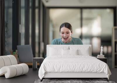 Overjoyed surprised woman looking at the tablet screen, sitting at a work desk, reading good unexpected news in an email, or message, excited by a money refund, job promotion, or great sale offer. Wall mural