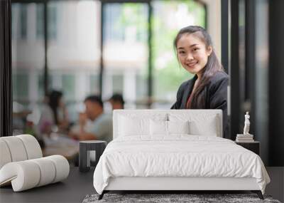 Portrait of smiling young business woman with arm crossed on office	 Wall mural