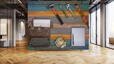 Top view typewriter ,a cup of coffee and engineer equipment on wooden background Wall mural