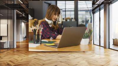 Young creative designer working at office Wall mural