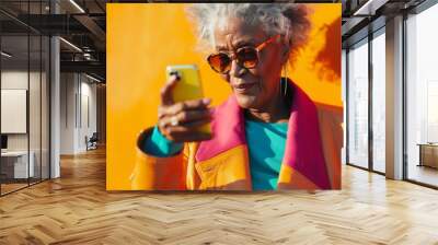 An older adult using a modern smartphone, dressed fashionably, high detail, vibrant colors, showcasing active and tech-savvy roles   Wall mural