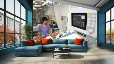 a doctor giving medical treatment at the bedside of a female patient in intensive care in a hospital. close-up of the patient's vital signs on the screen Wall mural