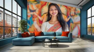 an indian woman smiling in white saree with goddess image background Wall mural